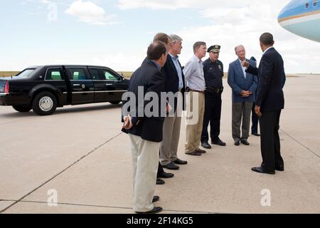 President Barack Obama talks with state and local officials upon his arrival at Buckley Air Force Base in Aurora Colo. July 22 2012. Pictured from left are: Rep. Ed Perlmutter D-Colo.; Sen. Michael Bennet D-Colo.; Sen. Mark Udall D-Colo.; Colorado Gov. John Hickenlooper; Police Chief Dan Oates; and Aurora Mayor Steve Hogan. Stock Photo