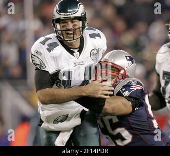 New England Patriots Junior Seau smiles while holding up the Lamar