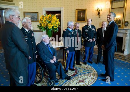 President Barack Obama speaks with retired U.S. Army Lieutenant Colonel Charles Kettles and his guests in the Blue Room following the Medal of Honor ceremony in the East Room of the White House July 18 2016. Then-Major Kettles distinguished himself in combat operations near Duc Pho Republic of Vietnam on May 15 1967 and is credited with saving the lives of 40 soldiers and four of his own crew members. Stock Photo