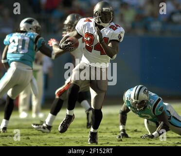 Tampa Bay Buccaneers' Carnell Cadillac Williams (24) maneuvers his way  through the Atlanta Falcons' defense at Raymond James Stadium December 24,  2005 in Tampa, FL. Williams finished the game with 31 carries