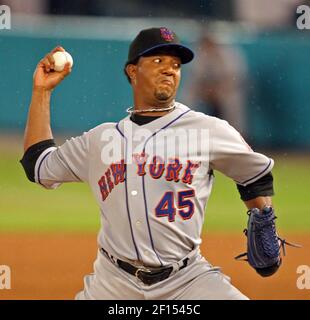 New York Mets pitcher Pedro Martinez puts his hand to his face after he was  taken out of the baseball game in the sixth inning against the Los Angeles  Dodgers in Los