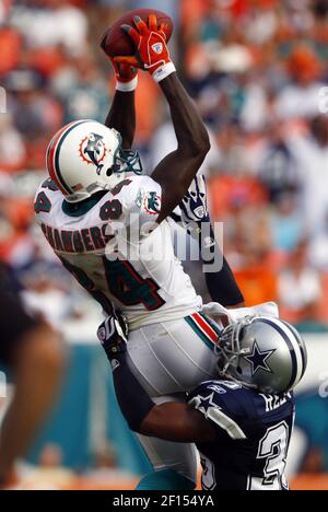 Miami Dolphins receiver Chris Chambers (84) picks up 7 yards before being  tackled by Dallas Cowboys cornerback Nathan Jones in the fourth quarter at  Dolphin Stadium in Miami on September 16, 2007. (