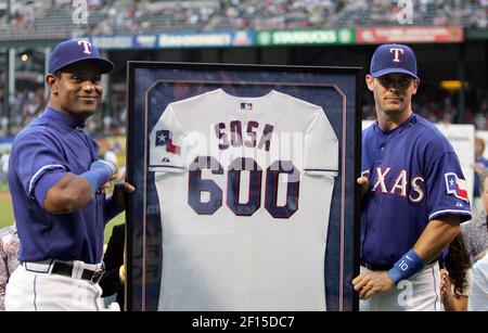 Texas Rangers Michael Young, right, is congratulated by teammate Josh  Hamilton after Young scored on a hit by Vladimir Guerrero in the third  inning against the Minnesota Twins during their baseball game