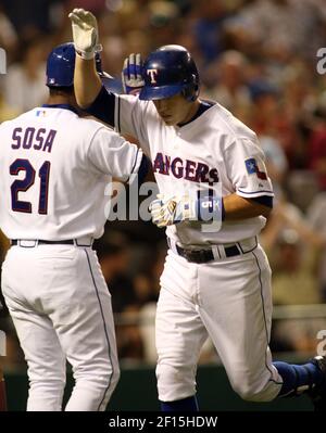 Texas Rangers' Ian Kinsler, right, walks off the field with Rangers manager  Ron Washington, left, after Kinsler's two home runs led the Rangers to a  5-1 win over the Seattle Mariners in