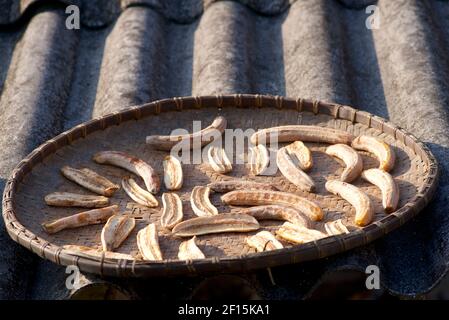 Still life. Bananas drying in a rattan basket on a corrugated roof. Near Sapa, Lao Cai Province, northern Vietnam Stock Photo