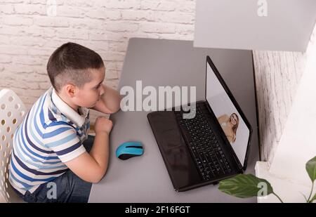 Child using gadgets to study. Education and distance learning for kids Stock Photo