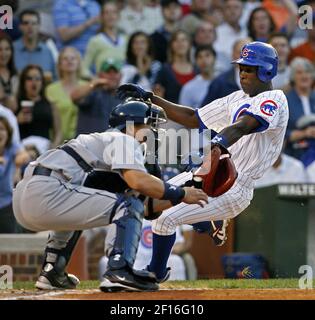 The Washington Nationals' Alfonso Soriano scores in front of Chicago Cubs'  pitcher Mark Prior after a wild pitch in the first inning of their game at  RFK Stadium in Washington, DC, on