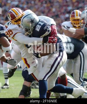 Dallas running back Julius Jones gets stopped for a loss by New