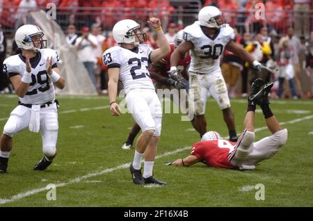 Penn State guard Rich Ohrnberger, second from left, reaches out and fixes  coach Joe Paterno's hair during team photos in State College, Friday, Aug.  8, 2008. Left is kicker Kevin Kelly (23)