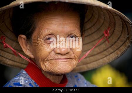 Portrait of an elderly Vietnamese woman in a distinctive conical hat. Hoi An, Vietnam Stock Photo