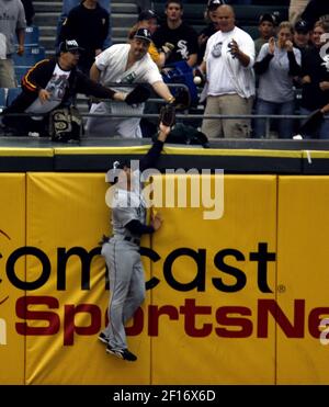 Seattle Mariners left fielder Raul Ibanez reaches out to make the catch on  a flyball hit by Tampa Bay Devil Rays' Travis Lee during the first inning  of their baseball game at