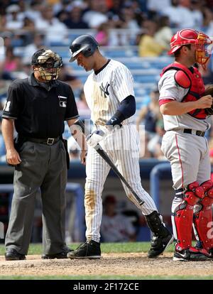 Home plate umpire Marvin Hudson warns New York Yankees manager Joe