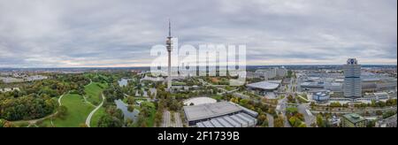 Panoramic aerial view over Munich, typical and authentic pano shot over the green olympic park, modern living at it's best. Stock Photo
