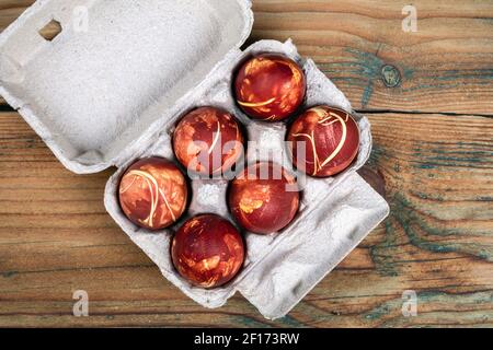 Coloured Easter eggs in onion skin, materials of nature for egg colouring tradition. Stock Photo