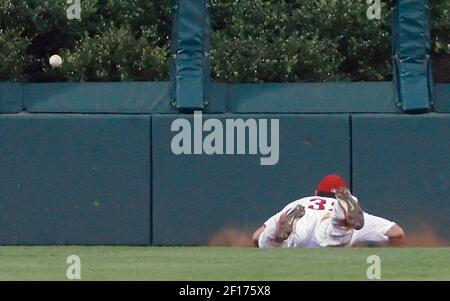 Philadelphia Phillies center fielder Aaron Rowand climbs he fence but  cannot reach a solo homer by San Diego Padres' MIke Cameron in the first  inning of their baseball game Monday, July 17