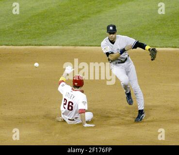 Philadelphia Phillies' Chase Utley tries to flip a ball to Jimmy