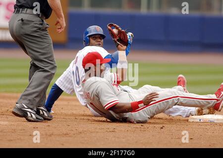 Philadelphia Phillies short stop Jimmy Rollins leaps into the air after  forcing Atlanta Braves runner Kelly Johnson at second base and completes  the double play in the seventh inning at Turner Field