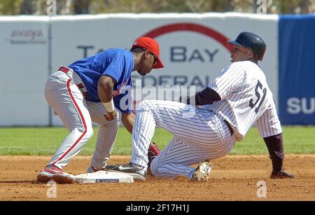 Philadelphia Phillies short stop Jimmy Rollins leaps into the air after  forcing Atlanta Braves runner Kelly Johnson at second base and completes  the double play in the seventh inning at Turner Field