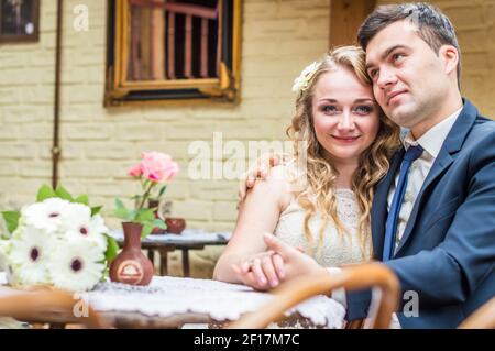 Newlyweds sitting in the Cafe Stock Photo