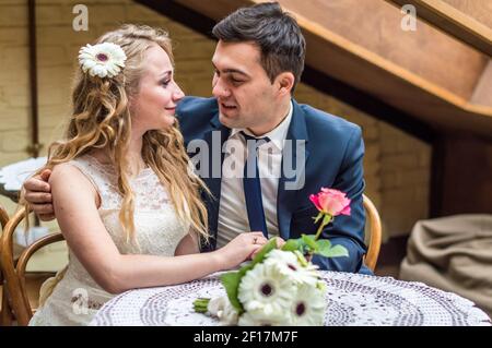 Newlyweds sitting in the Cafe Stock Photo