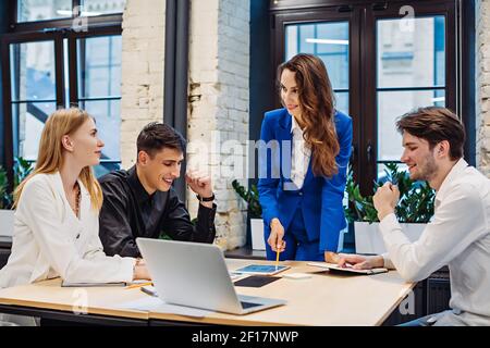 Businesswoman show graph on tablet to colleagues Stock Photo
