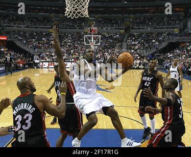 Miami Heat's Alonzo Mourning, right, defends the basket against Los Angeles  Clippers' Corey Maggette during the first quarter on Monday, Dec. 5, 2005,  in Los Angeles. Clippers are wearing their road Buffalo