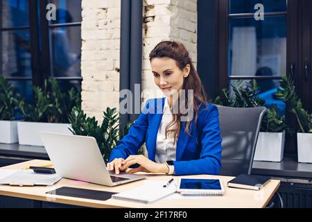businesswoman working on laptop in office Stock Photo