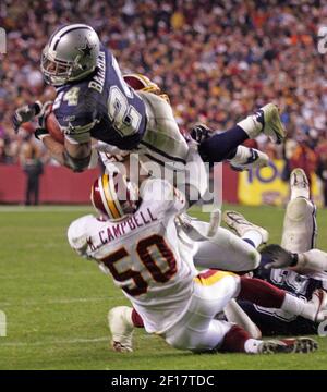 Washington Redskins defenders Sean Taylor (21) Phillip Daniels (93) and  Khary Campbell (50) stop Indianpolis Colts