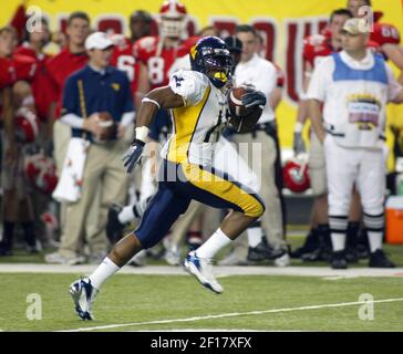 West Virginia's Steve Slaton (10) runs away from East Carolina's