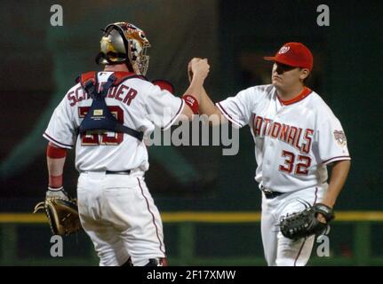 Brian Schneider (left) and Chad Cordero of the Washington Nationals,  celebrate victory against the Chicago Cubs on May 15, 2005. The Nationals  defeated the Cubs 5-4, to take the 3-game series three