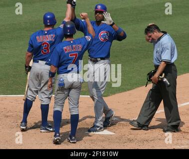 Chicago Cubs' Derrek Lee is congratulated by coach Mike Quade after his  home run in the first inning against the San Diego Padres in a baseball  game Tuesday, Aug. 18, 2009, in