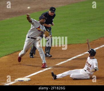 The ball sails past the outstretched glove of New York Mets third baseman David  Wright as Houston Astros Adam Everett, right, slides safely in after  stealing second and taking third on an