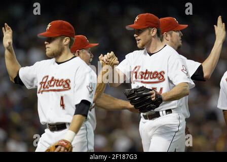 Houston Astros manager Phil Garner, left, walks off the mound as pitcher Andy  Pettitte (21) rubs his head after being hit in the stomach with a line  drive hit by Chicago Cubs