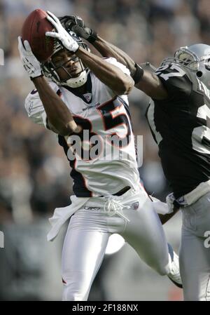 Oakland Raiders' Fabian Washington, (27), hangs his head as teammate  Michael Huff watches the replay of San Diego Chargers' LaDainian  Tomlinson's fourth touchdown during their NFL football game Sunday, Oct.  14, 2007