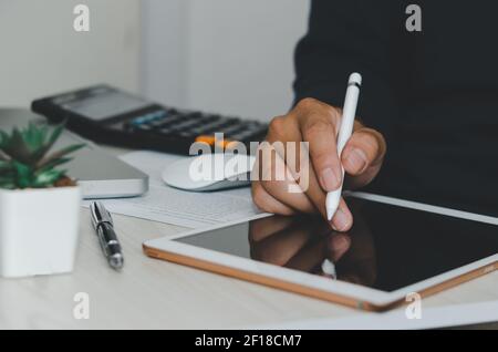 Man using  digital tablet or work on table, earning online business concept. Stock Photo
