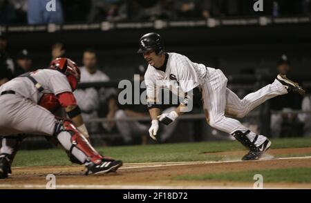 Chicago White Sox's Aaron Rowand (33) greets Geoff Blum (27) after Blum  crossed the plate after hitting a solo homer during the 14th inning in game  3 of the World Series, October