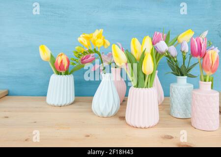 Colorful spring flowers in small vases Stock Photo