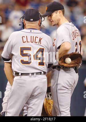 Detroit Tigers pitching coach Bob Cluck, left, reaches out to