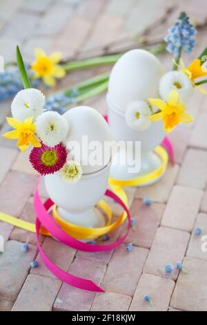 Eggs in egg cups with small flowers Stock Photo