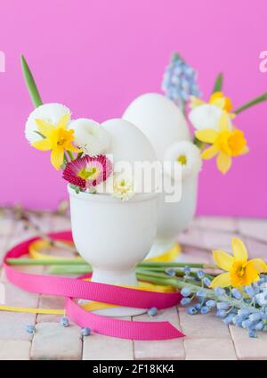 Eggs in egg cups with small flowers Stock Photo