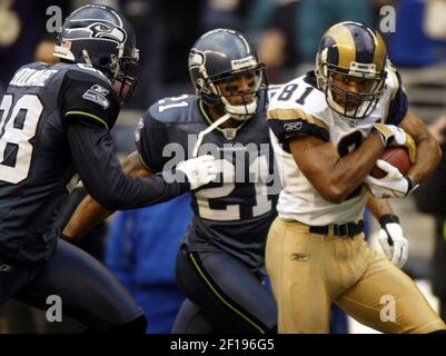 Seattle Seahawks' Ken Lucas (21) tackles Tampa Bay Buccaneers' wide  receiver Tim Brown during Sunday's game against the Seattle Seahawks at  Raymond James Stadium on Sept. 19, 2004 in Tampa, FL. The