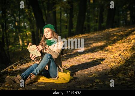Girl reading a book in the park laid down on the grass Stock Photo - Alamy