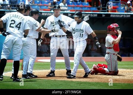 Florida Marlins' Jeff Conine, right, is congratulated by teammate Mike  Lowell after connecting on a two-run home run against Atlanta Braves  pitcher Mike Hampton during the first inning Saturday, April 24, 2004