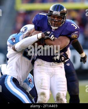 Tennessee Titans Keith Bulluck (53) attempts to tackle Denver Broncos  running back Tatum Bell (26) at Invesco Field at Mile High in Denver,  Colorado, Saturday, August 19, 2006, in NFL preseason action. (