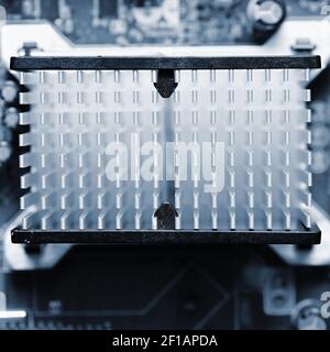 Computer motherboard with heat sink. Printed Circuit Board. Background concept for electrical engineering and modern technology. Stock Photo