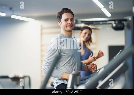 Two people working out on treadmill Stock Photo