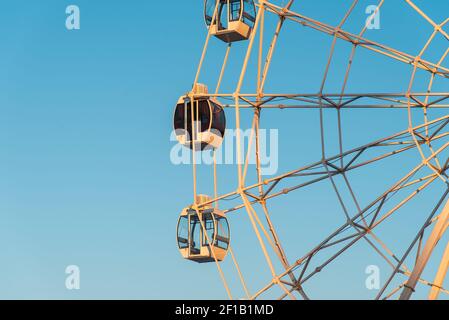 Ras al Khaimah, United Arab Emirates - January 13, 2021: Large Ferris wheel in Ras Al Khaimah corniche area at sunset in the heart of northern emirate Stock Photo