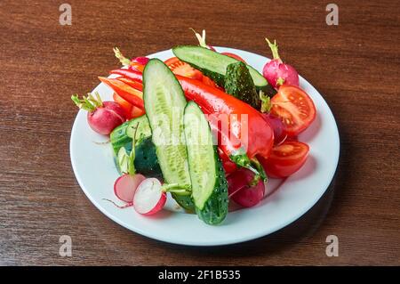 slicing fresh vegetables on a plate Stock Photo