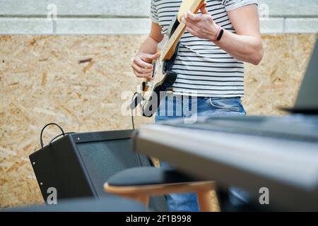 Handsome man playing guitar in studio Stock Photo