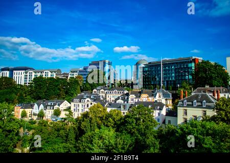 Luxembourg city, Luxembourg - July 15, 2019: Typical old buildings in contrast with modern glass buildings against blue sky in Luxembourg city Stock Photo